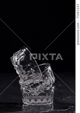Small glass cups isolated on black background. 75063147