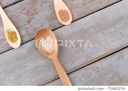 Variety of spices in wooden spoons. Variety of spices in wooden spoons. 75063254