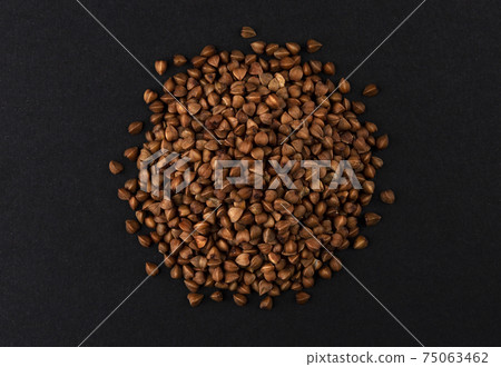 Top view of buckwheat groats on black background Top view of buckwheat groats on black background 75063462