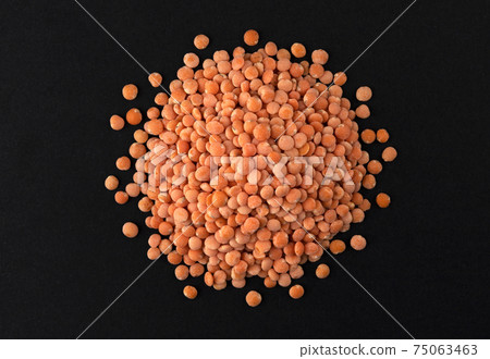 Top view of red lentils on black background Top view of red lentils on black background 75063463