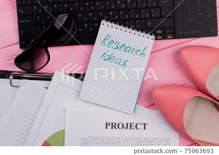 Set of women's accessories desk - notebook, shoes, sun glasses on pink background. 75063693