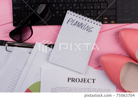 Styled woman's workplace with keyboard, notepad and various papers. Styled woman's workplace with keyboard, notepad and various papers. 75063704