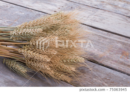 Cereal ears on wooden background. Cereal ears on wooden background. 75063945