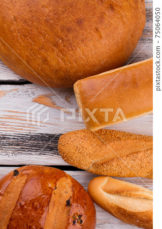 Various bread on wooden background, top view. 75064050
