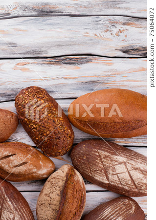 Freshly baked bread loaves, top view. Freshly baked bread loaves, top view. 75064072