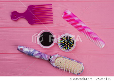 Hair combs and brushes on wooden background. Hair combs and brushes on wooden background. 75064170