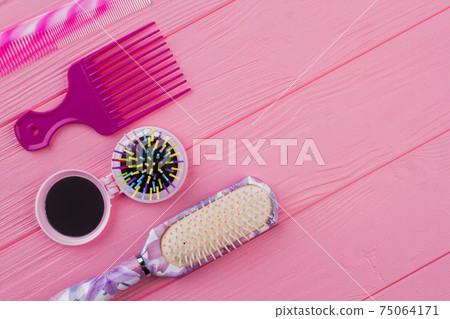 Various colored brushes and combs for hair. 75064171