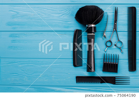 Professional hairdresser set on blue wooden background. Professional hairdresser set on blue wooden background. 75064190