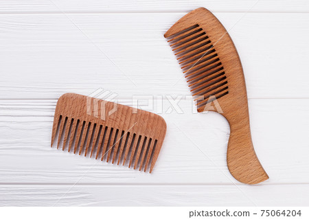 Wooden hair combs on white background. Wooden hair combs on white background. 75064204
