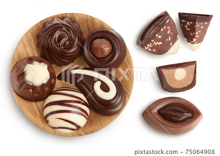 Chocolate candy in wooden bowl isolated on white background with clipping path and full depth of field. Top view. Flat lay 75064908