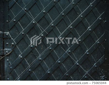 Vintage metal background, forged metal door, robust Vintage metal background, forged metal door, robust 75065044