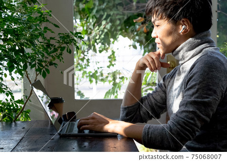 A man working while having a conversation online A man working while having a conversation online 75068007