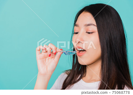 woman smiling wear putting silicone orthodontic retainers 75068778