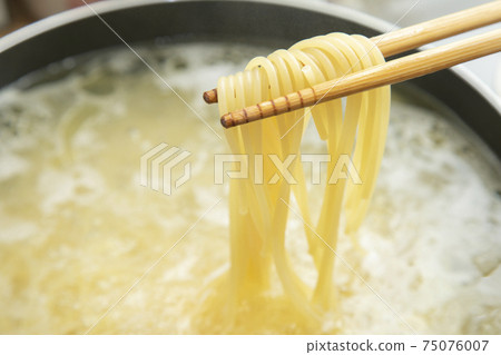 Scene of raising boiled pasta with chopsticks Scene of raising boiled pasta with chopsticks 75076007