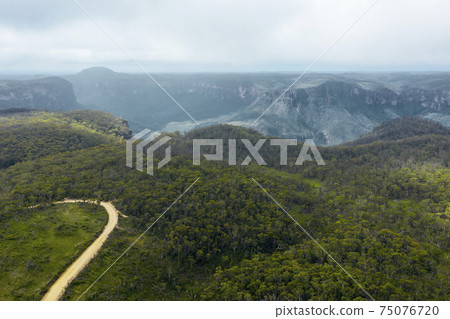 Aerial view of a dirt track in the Grose Valley in The Blue Mountains in Australia Aerial view of a dirt track in the Grose Valley in The Blue Mountains in Australia 75076720