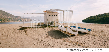 Two boats on the sand at Jaz beach in Montenegro. Two boats on the sand at Jaz beach in Montenegro. 75077406