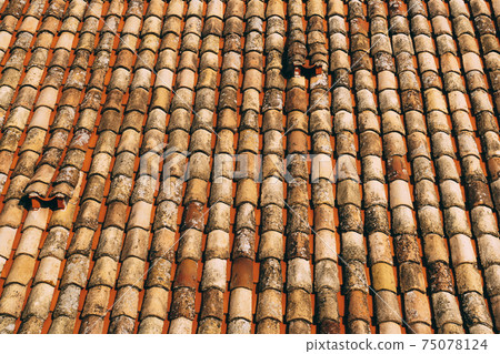 The texture of the old brown shingles on the roof of the building. The texture of the old brown shingles on the roof of the building. 75078124