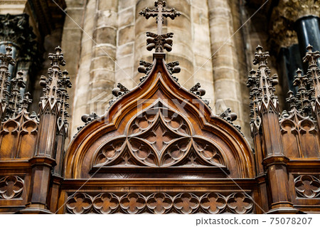 Gothic architecture. Cross on a wooden base with patterns. Prayer booth. Gothic architecture. Cross on a wooden base with patterns. Prayer booth. 75078207