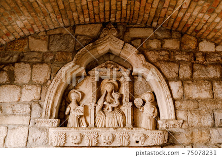 Bas-relief in the niche of the Kotor Sea Gate depicting the Madonna and Child. Bas-relief in the niche of the Kotor Sea Gate depicting the Madonna and Child. 75078231