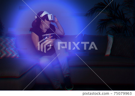 Woman watching movie at home using vr headset Woman watching movie at home using vr headset 75079963