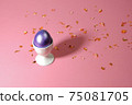 Easter egg of purple color in a white stand on a pink background. 75081705