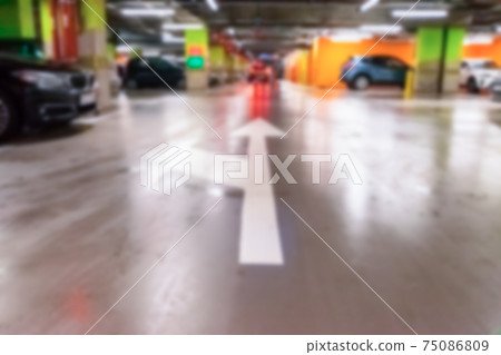 Parking space blurred. Empty road asphalt background in soft focus. Car lot parking space in underground city garage. Hidden underground carpark. 75086809