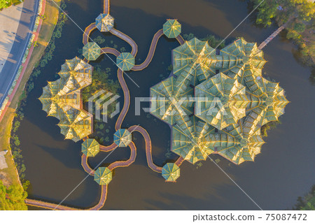 Aerial top view of The Ancient Siam City, the museum park with lake, in Samut Prakan Province, Bangkok, Thailand. Thai architecture temple. Tourist attraction landmark building. 75087472