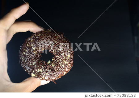 Cake, Donuts with chocolate topping sprinkled on top Cake, Donuts with chocolate topping sprinkled on top 75088158