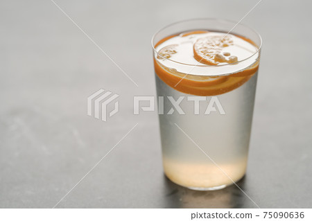 organic lemonade in tumbler glass on concrete background with copy space organic lemonade in tumbler glass on concrete background with copy space 75090636