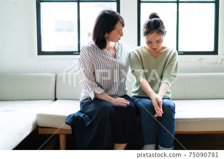 A woman who encourages depressed friends A woman who encourages depressed friends 75090781