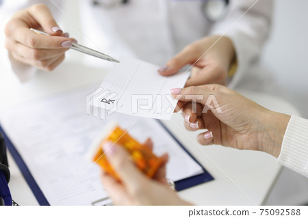 Doctor giving patient paper prescription for medicine closeup Doctor giving patient paper prescription for medicine closeup 75092588