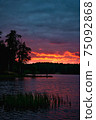 Red sunset with clouds over lake in forest in 75092868