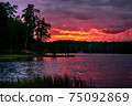 Red sunset with clouds over lake in forest in 75092869