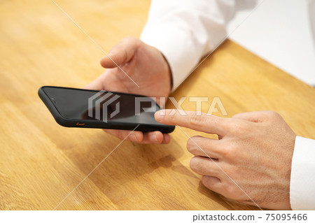 Businessman's smartphone 75095466