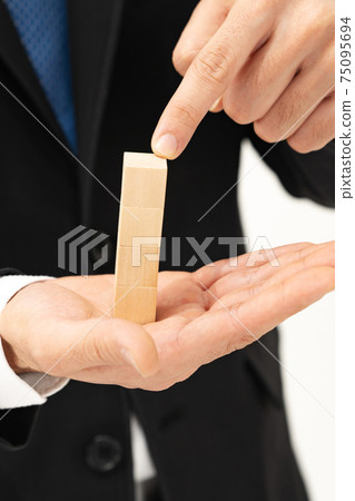 Business image Men who pile up blocks 75095694