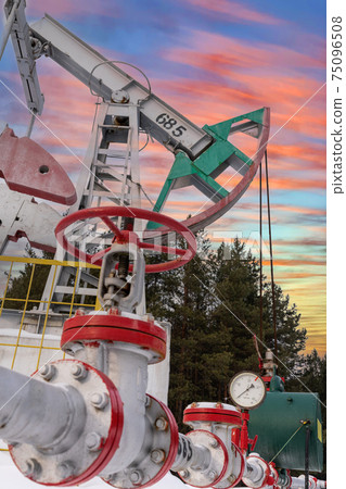 Oil pumpjack winter working. Oil rig energy industrial machine for petroleum Oil pumpjack winter working. Oil rig energy industrial machine for petroleum 75096508