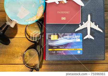 Credit card and airplane model on wooden table 75096981