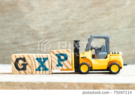 Toy forklift hold letter block P to complete word GXP on wood background Toy forklift hold letter block P to complete word GXP on wood background 75097114