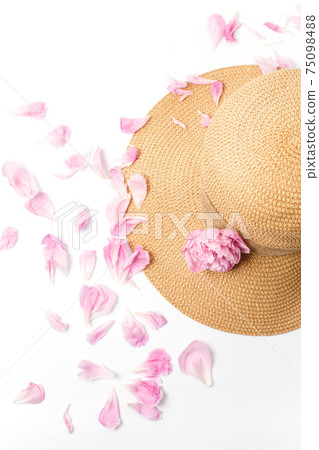 Summer vacation concept, straw braided hat, pink peony flowers and petals on white background Summer vacation concept, straw braided hat, pink peony flowers and petals on white background 75098488