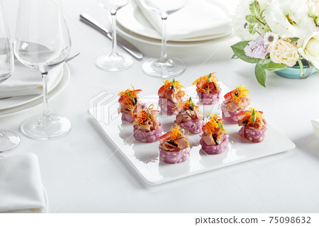Outdoor catering banquet in summer. Table with snacks and canapes at a summer banquet 75098632