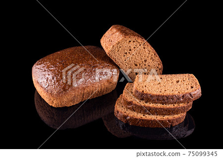 Freshly baked homemade bread isolated on black. Cut in half rye bread with slices. Healthy eating and traditional bakery, baking bread concept 75099345
