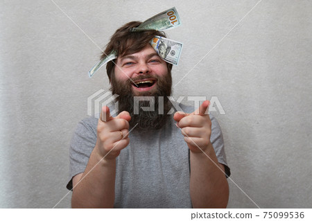 Laughing bearded man with dollars on his head. Laughing bearded man with dollars on his head. 75099536