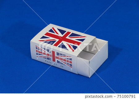 Union Jack flag on white box with barcode and the color of nation flag on blue background 75100791