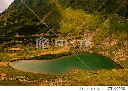 Alpine lake of the Carpathians Brebeneskul, the highest lake in Ukraine. Alpine lake of the Carpathians Brebeneskul, the highest lake in Ukraine. 75100968