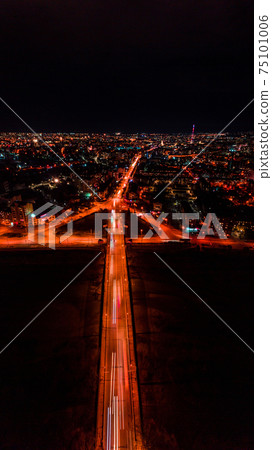 Panorama of night aerial view of the city of Ivano-Frankivsk, bright lights from cars and night lighting of the city. 75101006