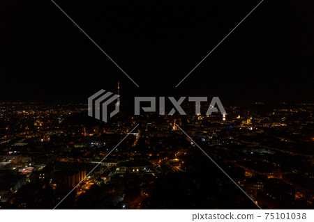 Night city of Lviv, aerial view, illuminated streets and squares of the city. 75101038