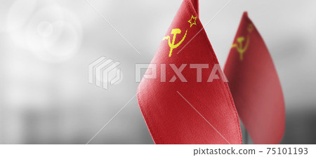 Small national flags of the USSR on a light blurry background Small national flags of the USSR on a light blurry background 75101193