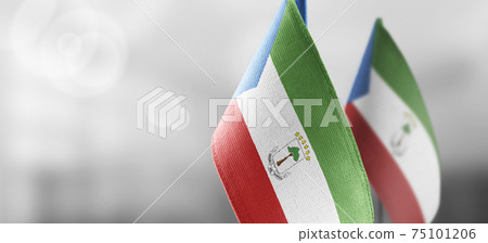 Small national flags of the Equatorial Guinea on a light blurry background Small national flags of the Equatorial Guinea on a light blurry background 75101206