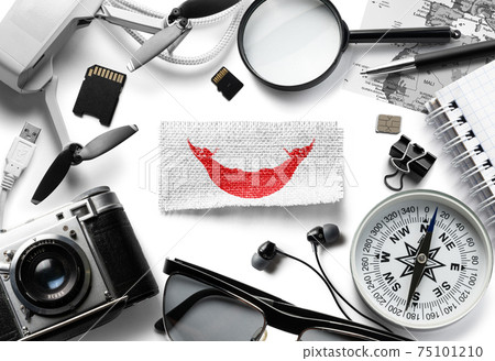 Flag of Easter Island and travel accessories on a white background. Flag of Easter Island and travel accessories on a white background. 75101210