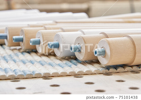 Lathe wooden legs folded on workbench extreme closeup 75101438